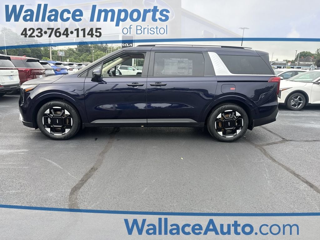 2026 Kia Carnival EX in Deep Chroma Blue — front three-quarter view